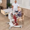 beka nora pro sit to stand sitting patient on chair and caregiver 600x600